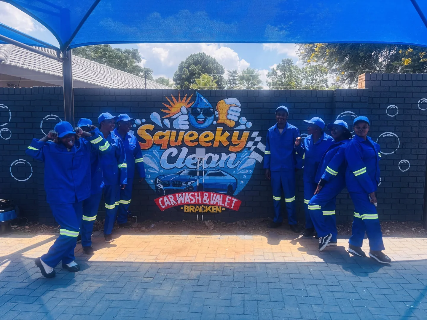 Squeeky Clean team beside the Bracken car wash sign